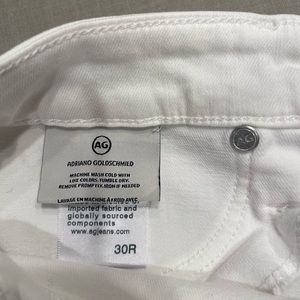 White AG skinny with frayed bottom. Worn only a few times. No stains.